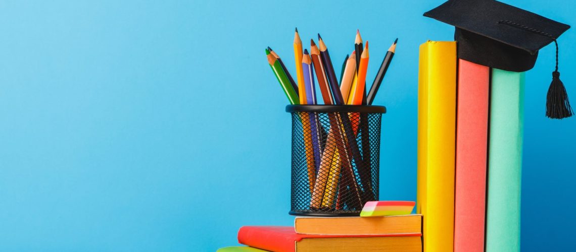 cup-color-pencils-stack-books-table-scaled